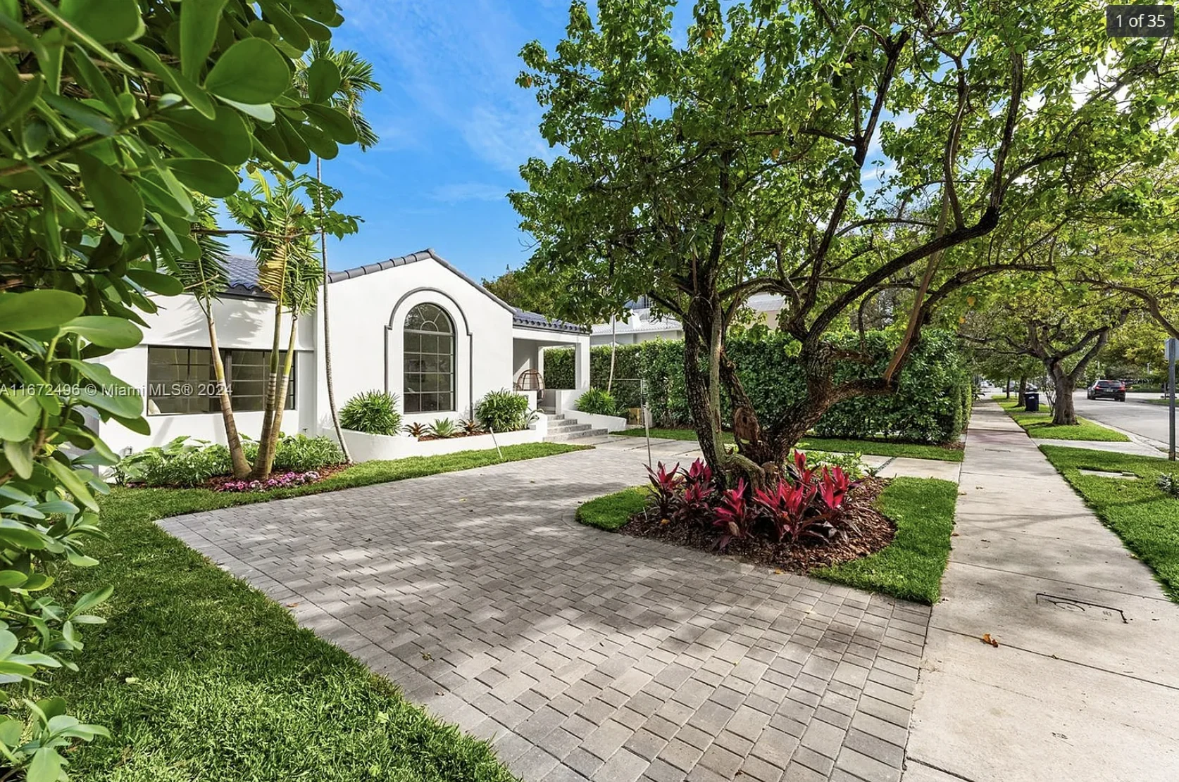 Completed historic residence addition in Miami Beach, framed by mature trees